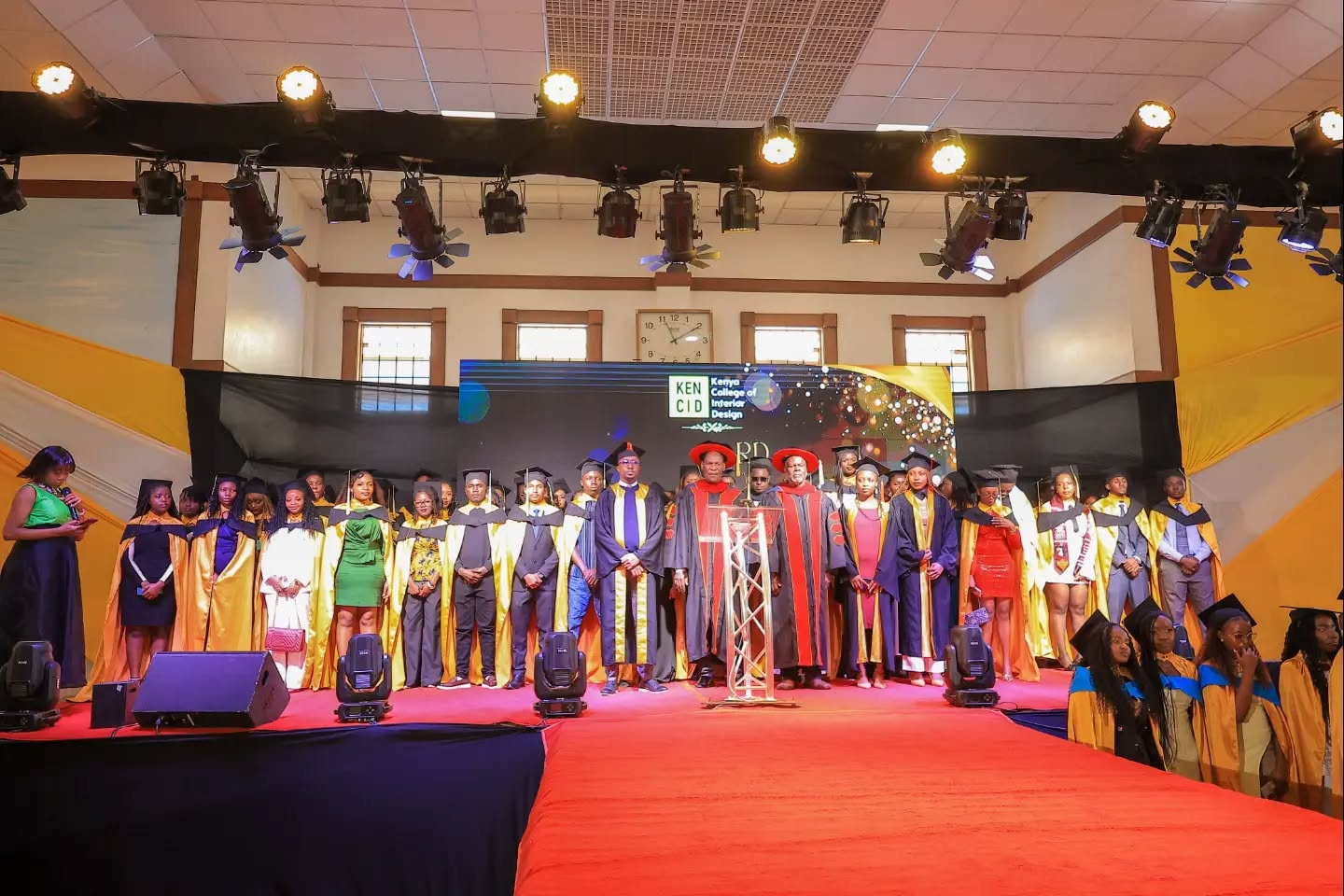 Graduates and academic leaders standing together on stage