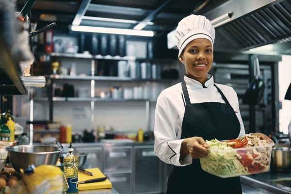 Hospitality professional preparing fresh food in a training kitchen